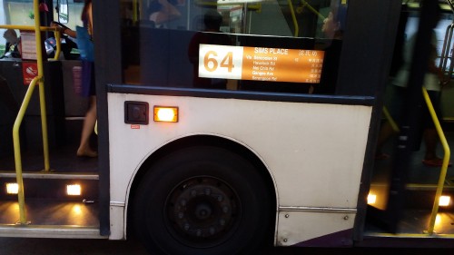 Desto being displayed on a Volvo Olympian in the evening