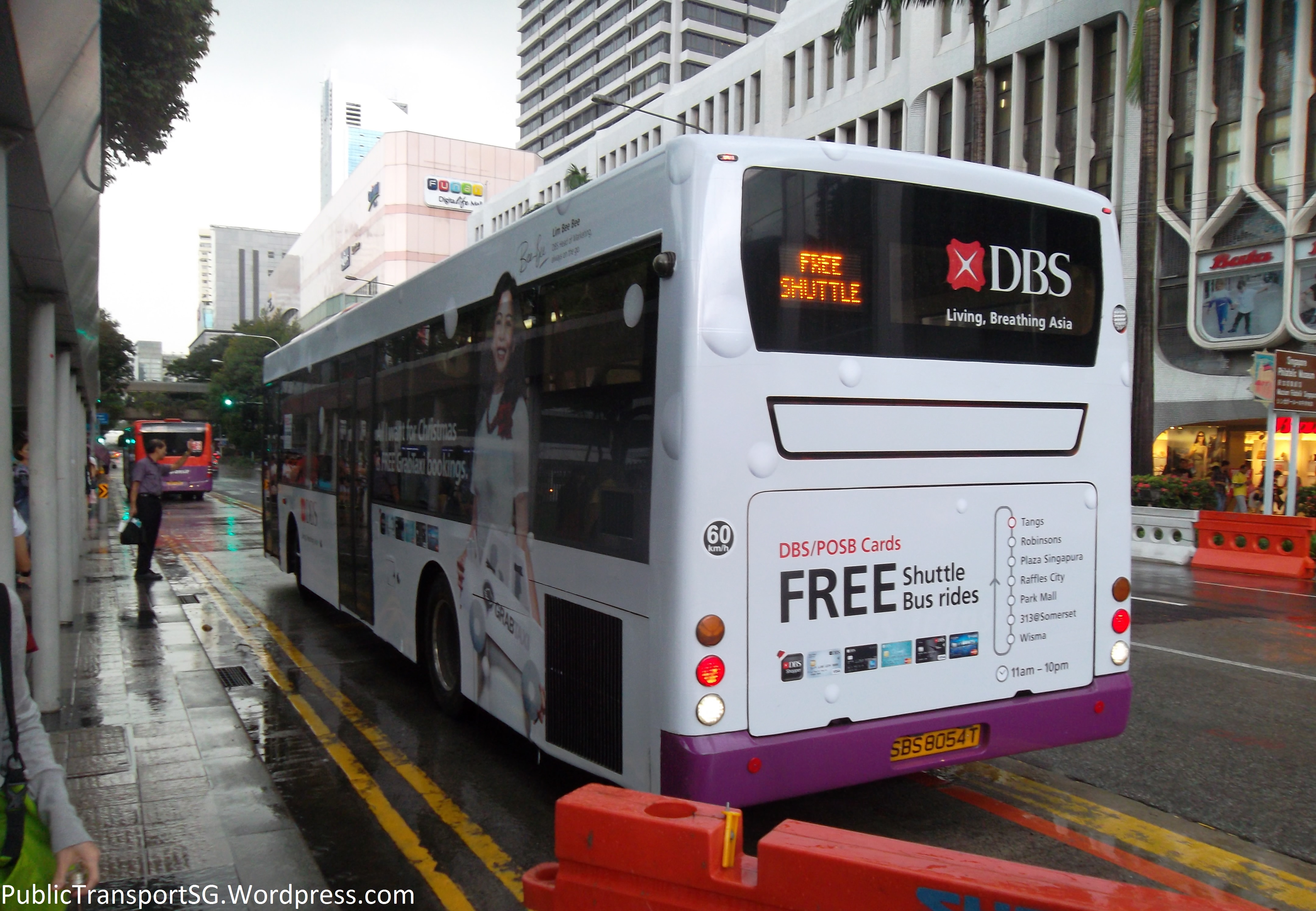 The rear of SBS8034T, one of the shuttle buses, with the DBS Bank Christmas Bus advertisement.