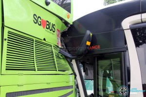The left mirror of the SMRT bus bent backwards, and damage to the air conditioning grill of the SBS Transit bus