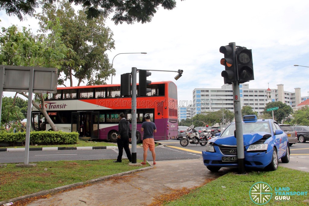 View of accident vehicles. Damage to the overhead traffic light can be seen.