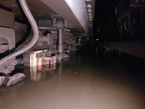 Partially submerged train. As an indicator of water depth, the current collector shoe is fully underwater.