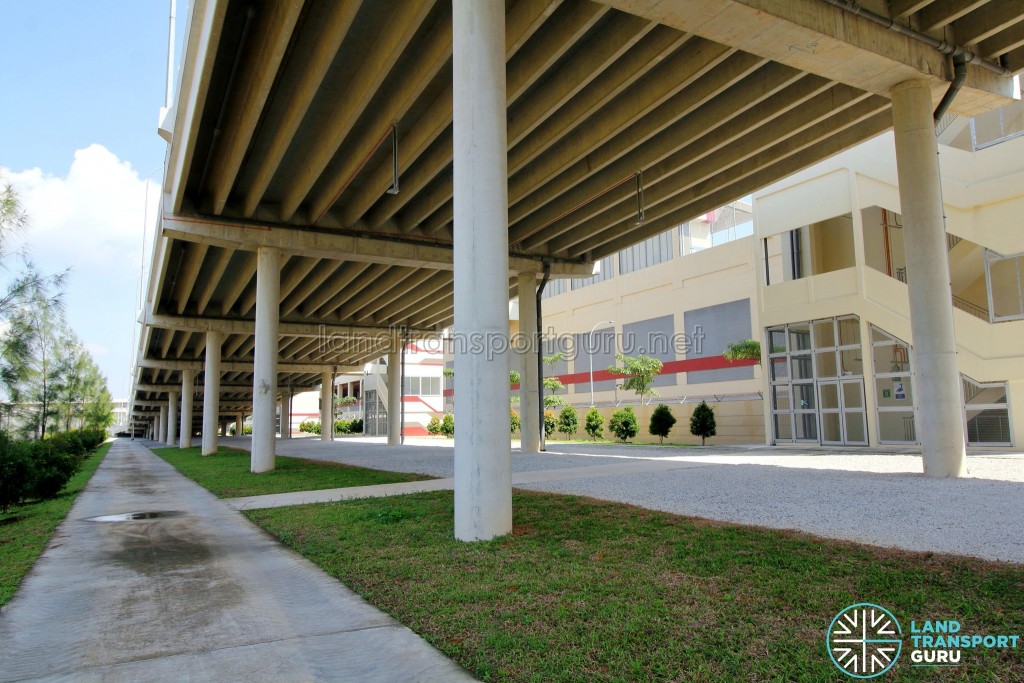 Tuas Bus Terminal - Public area underneath vehicular ramp with emergency stairs on the right